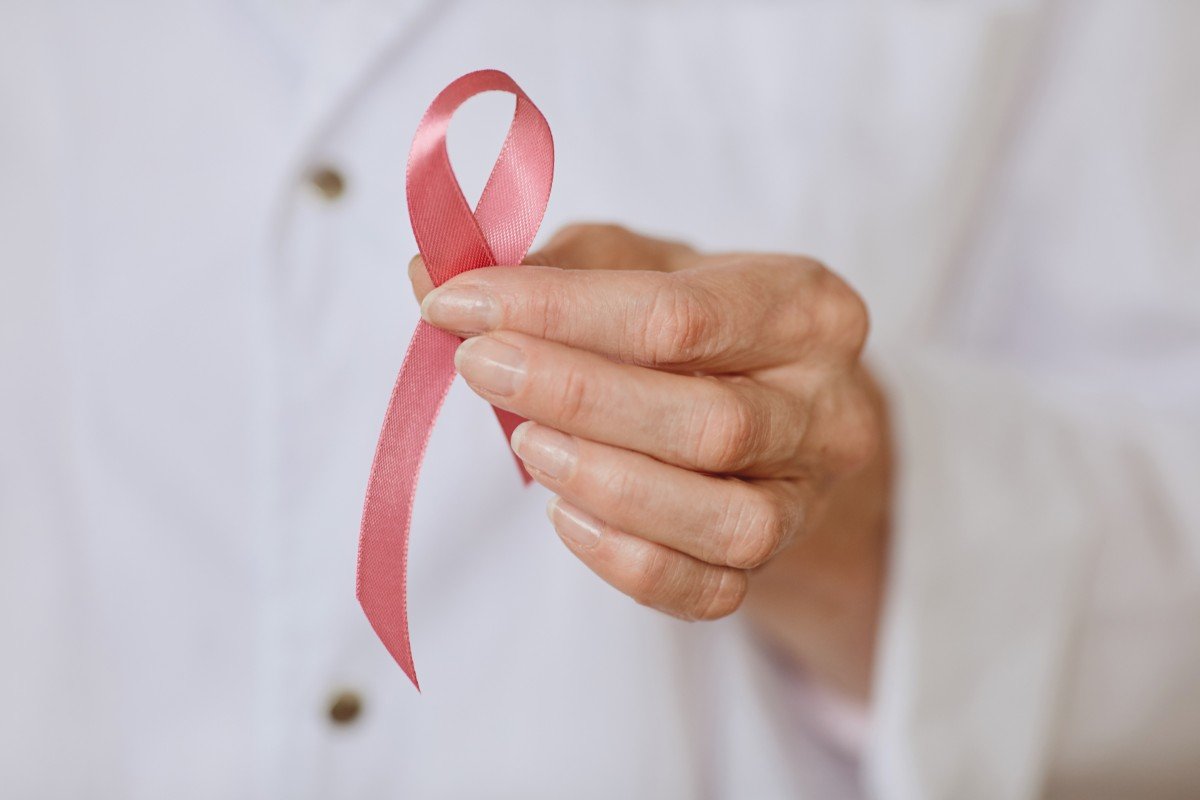 Doctor Holding Pink Ribbon Close Up